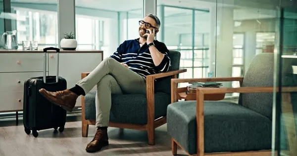 Corporate meeting setup with business travellers in a premium airport lounge environment