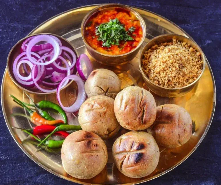 Traditional Rajasthani Dal Baati Churma served with ghee at a local Udaipur restaurant